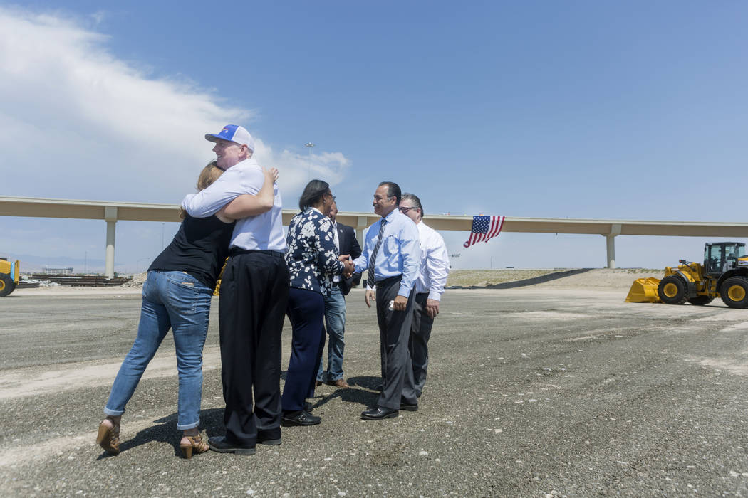 Nevada Department of Transportation employees celebrate the opening of the Centennial Bowl flyover bridge linking westbound 215 Beltway and southbound U.S. Highway 95 in northwest Las Vegas, Wedne ...