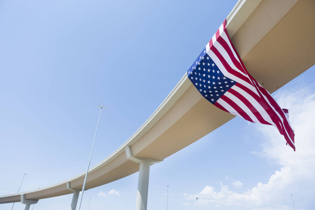 Employees with the Nevada Department of Transportation and Las Vegas Paving  Corp. celebrate the opening of the Centennial Bowl flyover bridge linking  westbound 215 Beltway and southbound U.S. High …