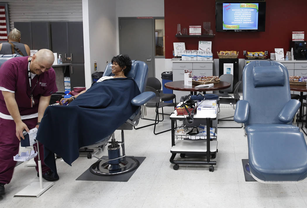 Eddie Herrera, left, phlebotomist, checks on Joy Holladay as she donates blood at United Blood Services on Tuesday, July 11, 2017, in Las Vegas. Bizuayehu Tesfaye Las Vegas Review-Journal @bizutesfaye