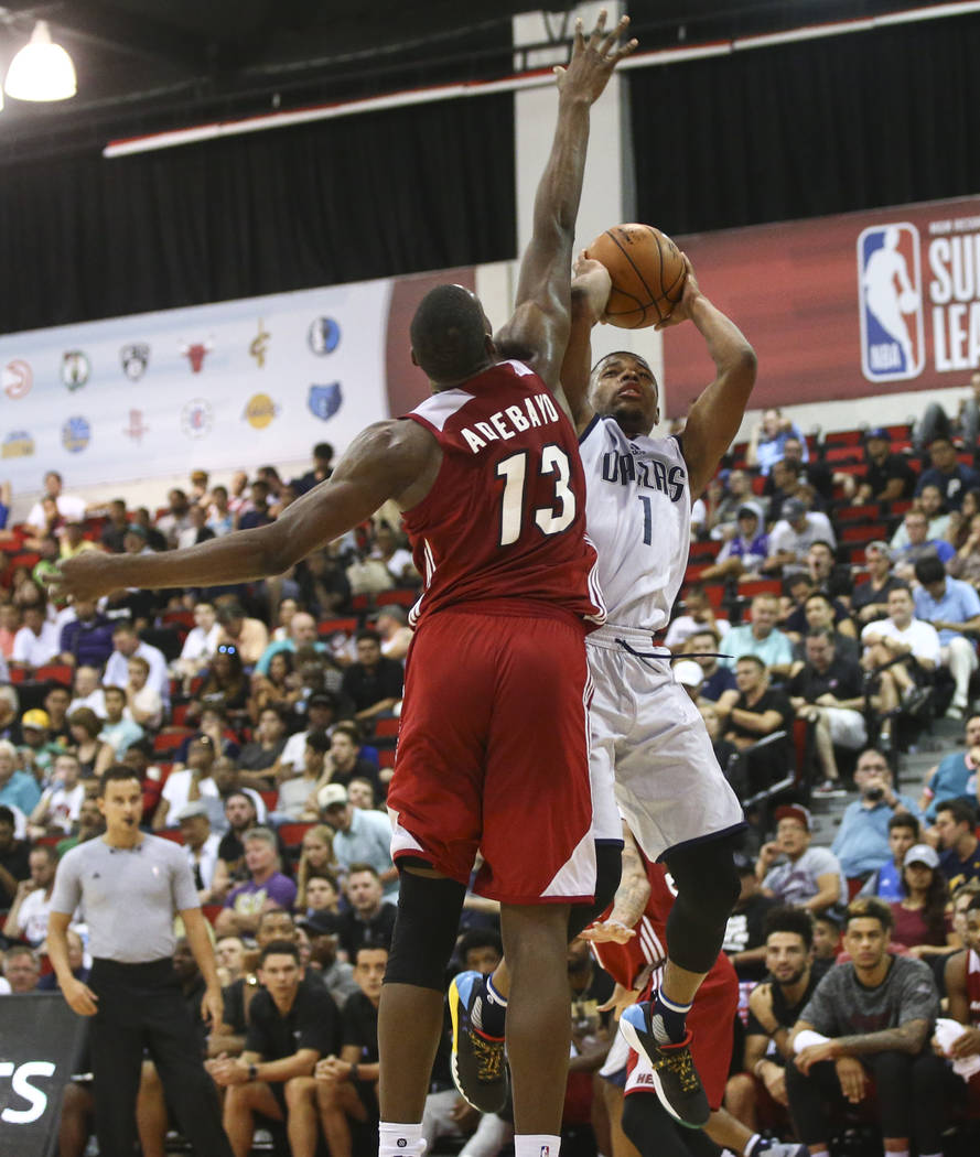 Miami Heat's Bam Adebayo (13) reaches out to block a shot from Dallas Mavericks' Dennis Smith Jr. (1) during a basketball game at the NBA Summer League at the Cox Pavilion in Las Vegas on Tuesday, ...