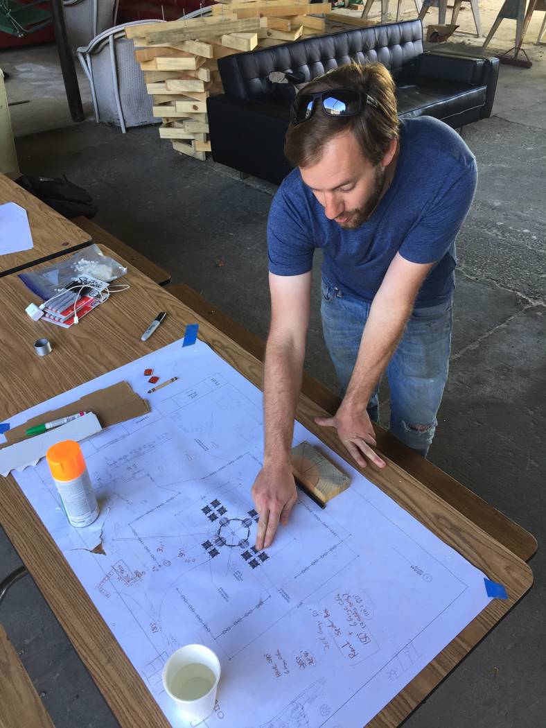 At a warehouse in Oakland, California, Friday, artist and architect Steve Brummond explains the plans for this year's Burning Man temple, which is being built out of trees killed by drought in the ...