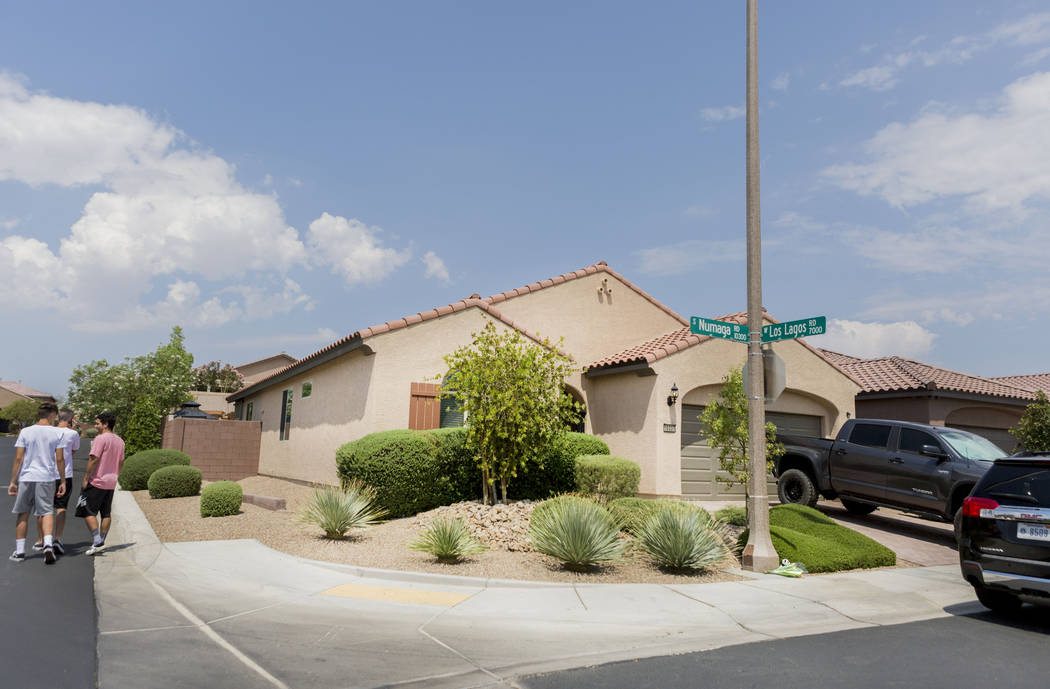 People walk passed the home of John Lunetta, 10337 S. Numaga Road, where the bodies were found Monday night in Las Vegas, Tuesday, July 11, 2017. Elizabeth Brumley Las Vegas Review-Journal