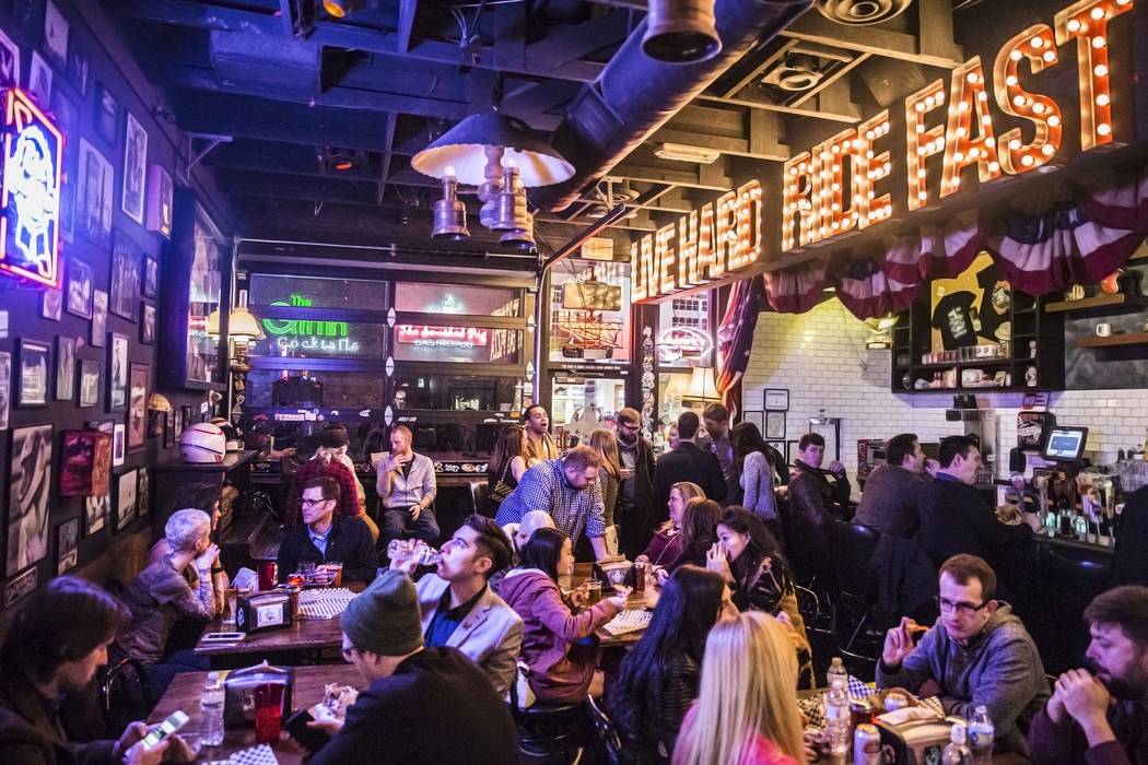 Diners eat and drink at Evel Pie, an Evel Knievel-themed pizzeria, on Fremont Street in downtown Las Vegas. (Benjamin Hager/Las Vegas Review-Journal)
