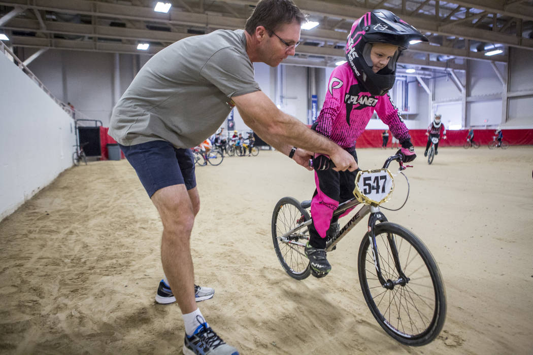 Richard Weatherhead helps his daughter Zoey, 6, warm up at the USA BMX 2017 Las Vegas Nationals at South Point Arena on Sunday, July 16, 2017. The Weatherheads came from Brisbane, Australia to rac ...