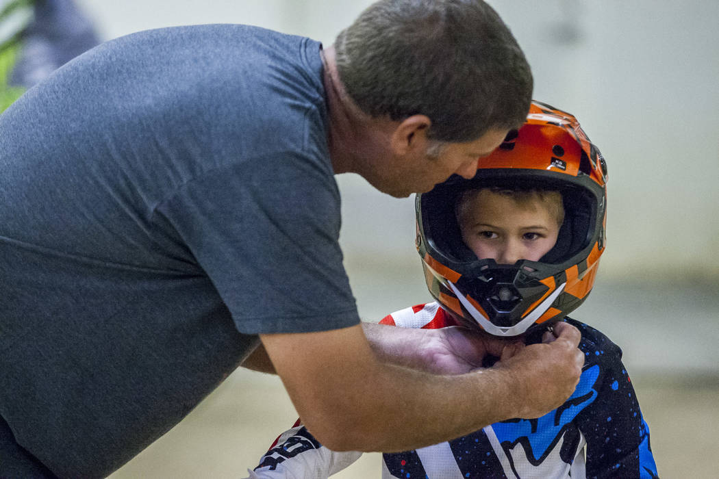 Matt Easley helps his son Tanner, 5, with his helmet at the USA BMX 2017 Las Vegas Nationals at South Point Arena on Sunday, July 16, 2017.  Patrick Connolly Las Vegas Review-Journal @PConnPie