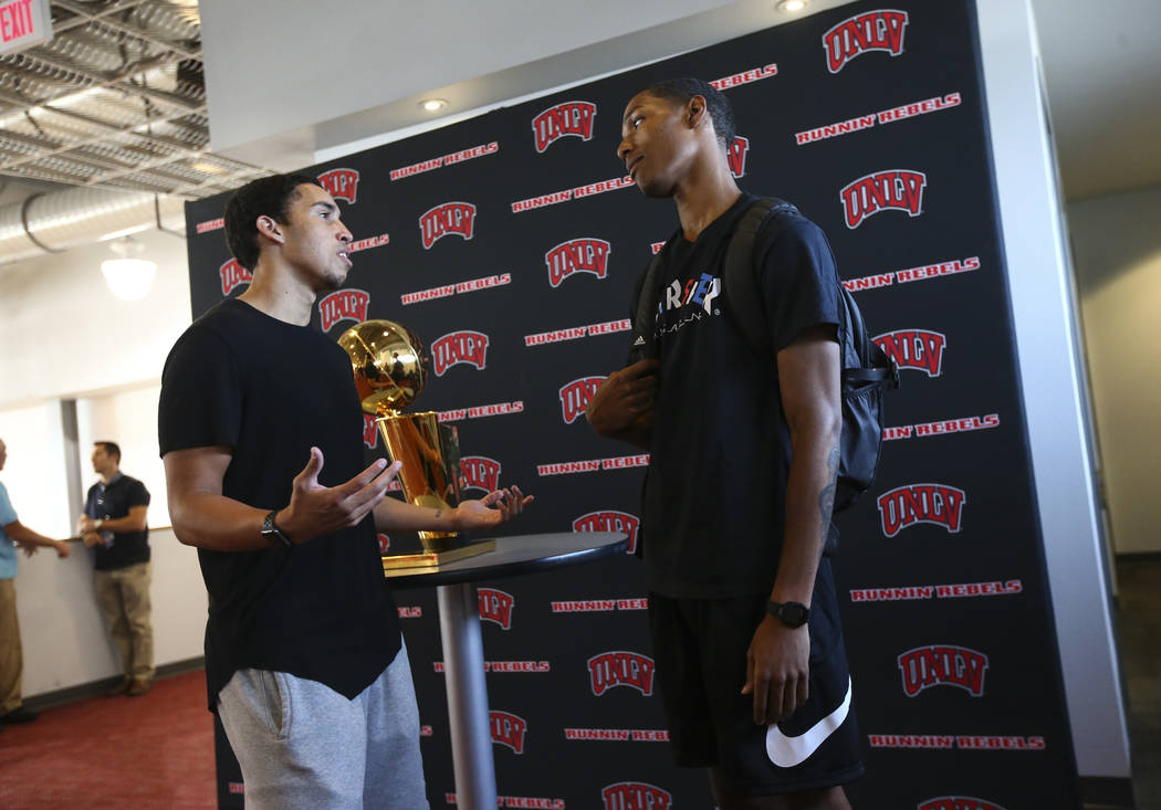 Golden State Warriors' Patrick McCaw, right, talks with fellow former UNLV player Austin Starr next to the Larry O'Brien Trophy in Mendenhall Center at UNLV in Las Vegas on Friday, July 14, 2017.  ...