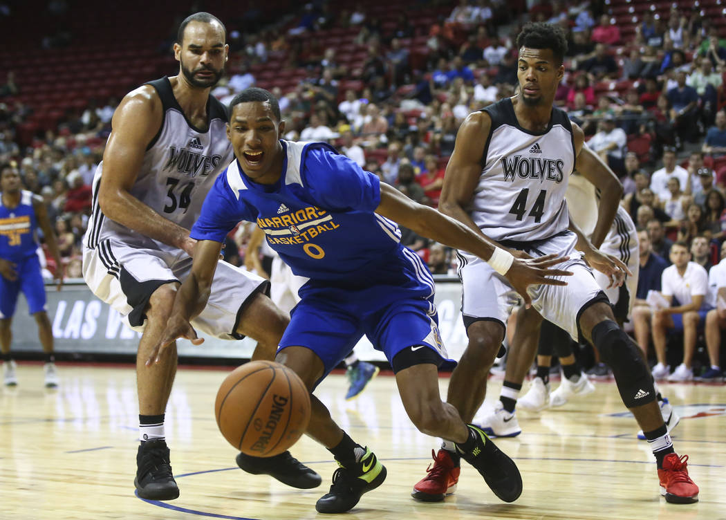 Golden State Warriors' Patrick McCaw (0) runs for the ball against Minnesota Timberwolves' Perry Ellis (34) and Charles Cooke (44) during a basketball game at the NBA Summer League at the Thomas & ...