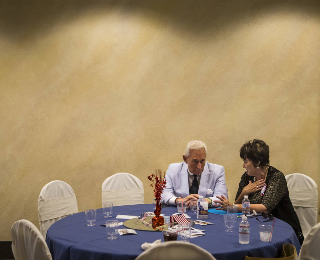 Political consultant Roger Stone, left, talks with Carol Bundy, wife of Cliven Bundy, at a fundraising event in support of the Bundy family at Rainbow Gardens in Las Vegas on Saturday, July 15, 20 ...