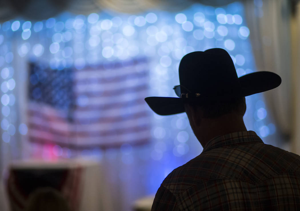 An attendee wearing a cowboy hat is silhouetted at a fundraising event in support of the Bundy family at Rainbow Gardens in Las Vegas on Saturday, July 15, 2017. Chase Stevens Las Vegas Review-Jou ...