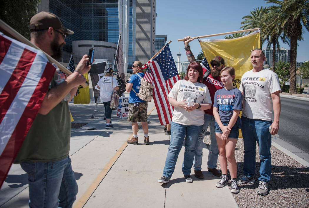 The Farnsley family from Phoenix gets their photo taken with Ace Baker, a leader of the American Warrior Revolution organization, at a rally to support defendants in the Bundy standoff case at the ...