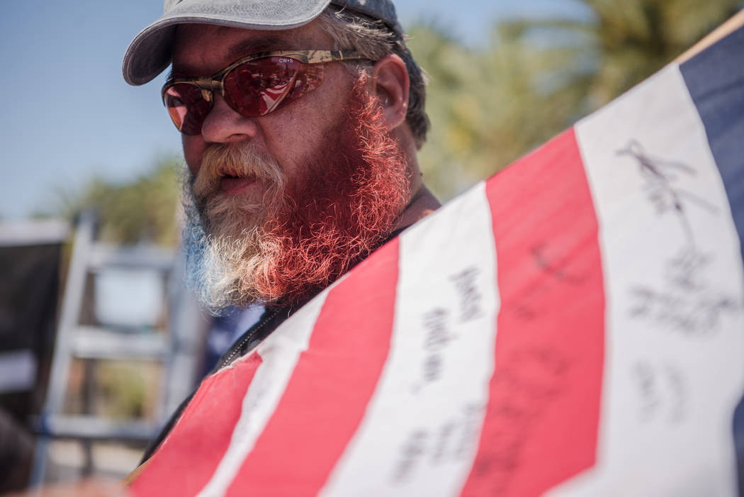 Georgia resident James Napier spray painted his beard the colors of the American flag at a rally to support defendants in the Bundy standoff case at the Lloyd George U.S. Courthouse on Saturday, J ...