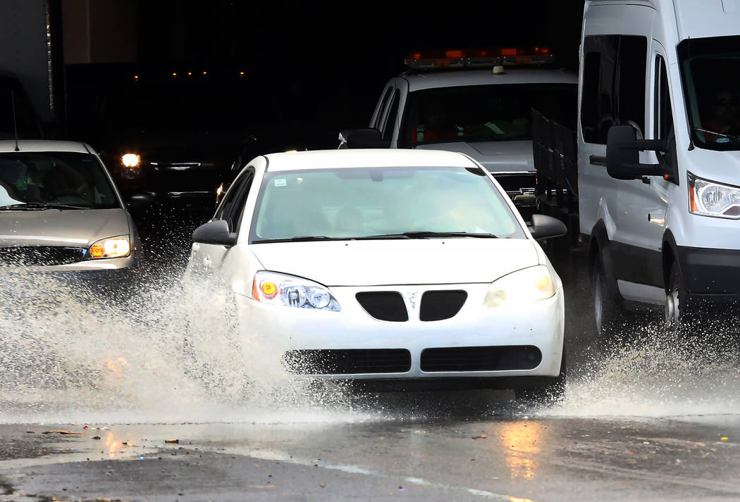 Motorists navigate through a flooded area on Bonanza Road during a quick rain shower Tuesday, July 11, 2017, in Las Vegas. (Bizuayehu Tesfaye/Las Vegas Review-Journal) @bizutesfaye