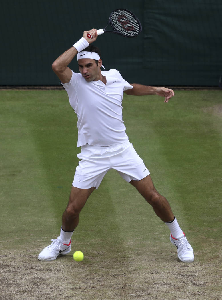 Switzerland's Roger Federer returns to Croatia's Marin Cilic during the Men's Singles final match on day thirteen at the Wimbledon Tennis Championships in London Sunday, July 16, 2017. (John Walto ...