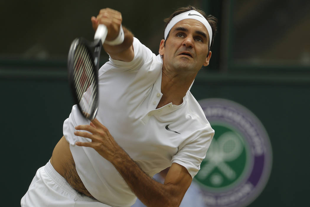 Switzerland's Roger Federer serves to Croatia's Marin Cilic in the Men's Singles final match on day thirteen at the Wimbledon Tennis Championships in London Sunday, July 16, 2017. (Alastair Grant/AP)