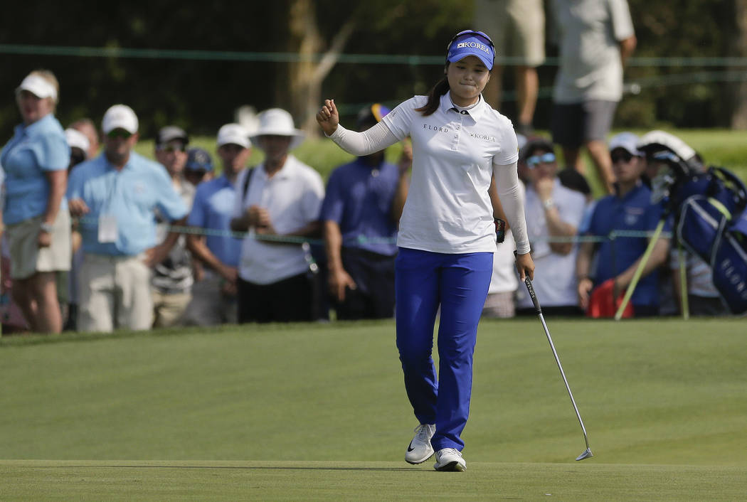 Hye-Jin Choi, of South Korea, reacts after sinking a putt for birdie on the seventh green during the final round of the U.S. Women's Open Golf tournament Sunday, July 16, 2017, in Bedminster, N.J. ...