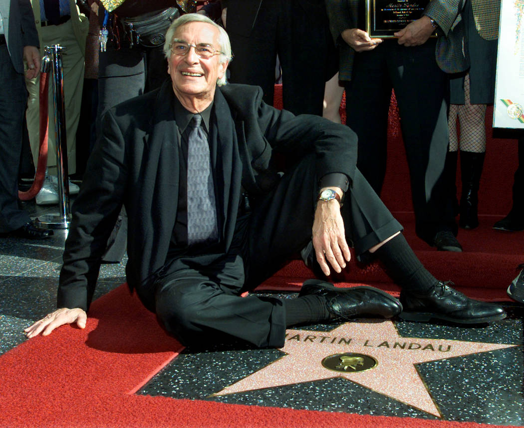 FILE PHOTO -  Academy award winning actor Martin Landau sits on his new star on the Hollywood Walk of Fame, as he poses for photographers during ceremonies to honor him, in Hollywood, December 17, ...