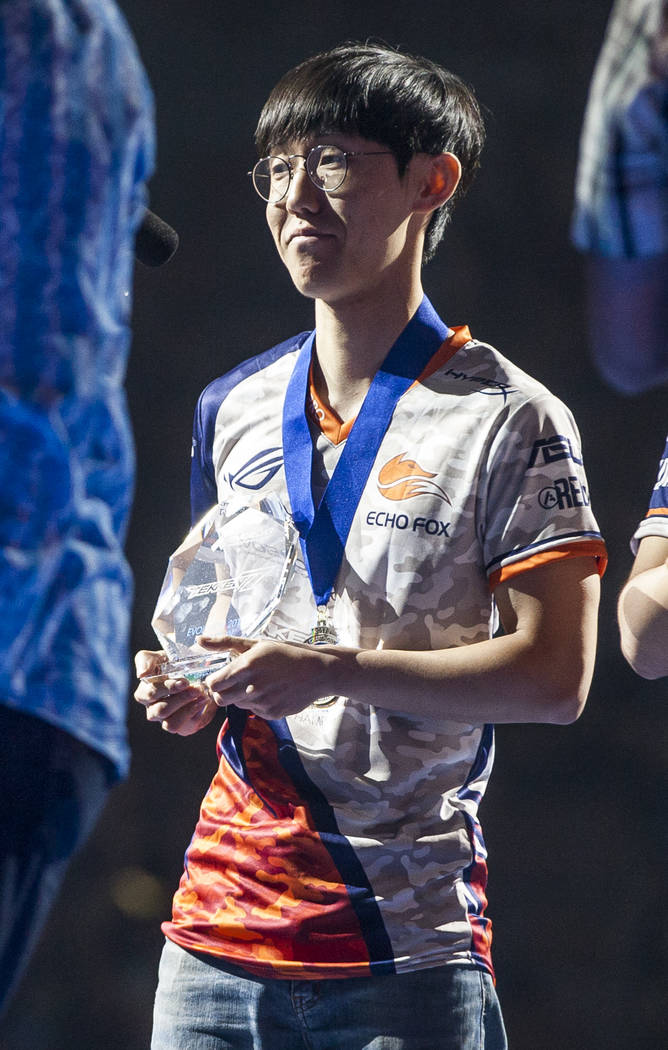 Hyun Jin Kim aka "JDCR" holds his trophy after being crowned winner of the Tekken 7 tournament during the Evo 2017 Championship Series, a fighting game tournament, at the Mandal ...