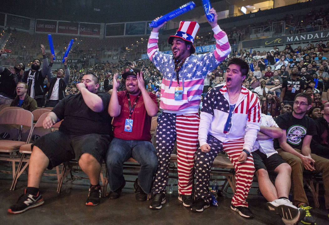 Atlanta Ngo, right, and Francisco Padilla, center right, cheer while sporting patriotic attire during the Evo 2017 Championship Series, a fighting game tournament, at the Mandalay Bay Events Cente ...