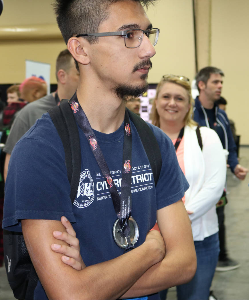 Chance Chhet, 17, waits in line to play the latest version of a video game called "Marvel vs. Capcom: Infinite" while his family, including his mom Renae Bonestroo, waits for him at the 2017 Evolu ...