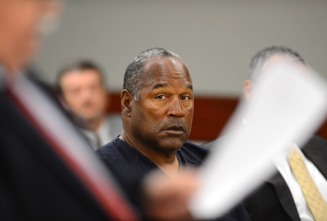 O.J. Simpson looks over at his lawyer Tom Pitaro during an evidentiary hearing in Clark County District Court on May 17, 2013 in Las Vegas. (Ethan Miller/AP, Pool)