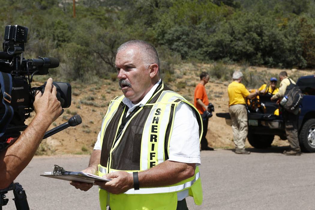 Gila County Sheriff's Office Detective David Hornung updates the media at the First Crossing recreation area during the ongoing search and rescue operation for a victim in a flash flood along the ...