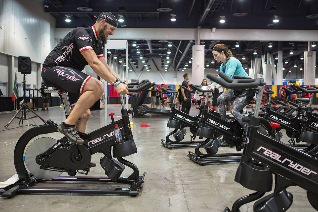 Real Ryder trainer Casey Stutzman, left, leads a brief cycle class during the IDEA World Fitness & Nutrition Expo at the Las Vegas Convention Center in Las Vegas on Thursday, July 20, 2017.  B ...