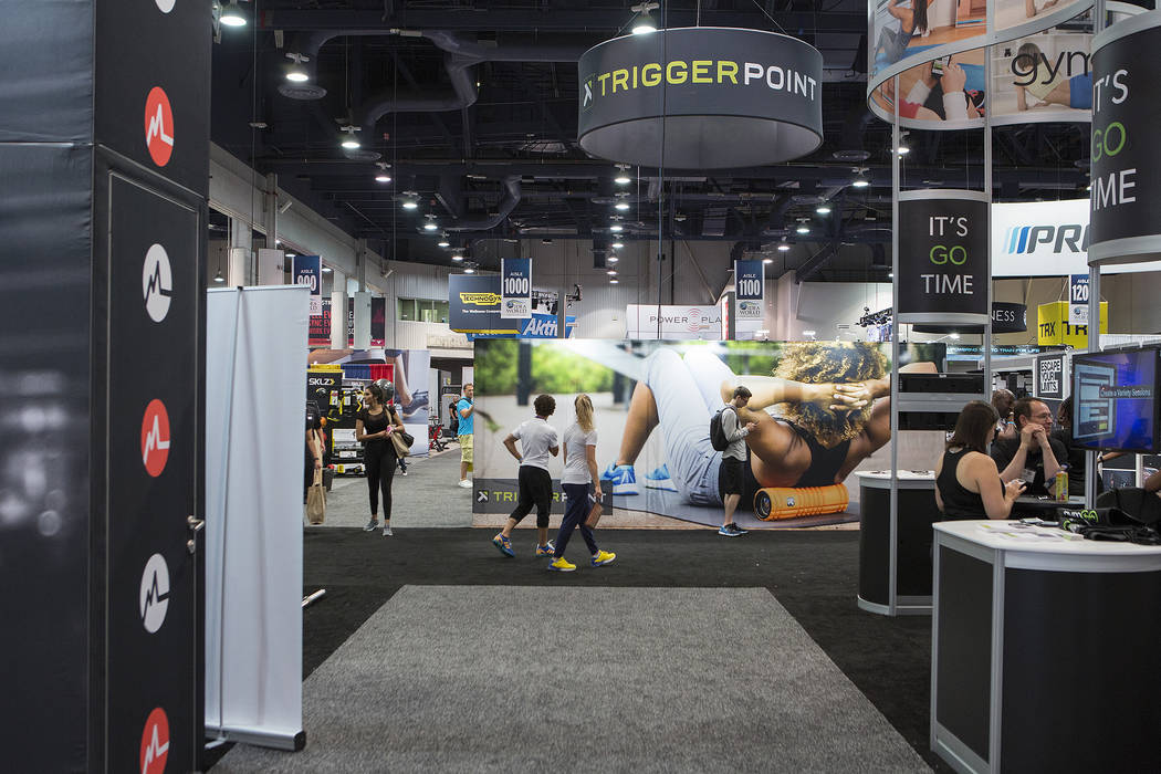 Attendees pass booths advertising workouts, fitness gear and other products during the IDEA World Fitness & Nutrition Expo at the Las Vegas Convention Center in Las Vegas on Thursday, July 20, ...