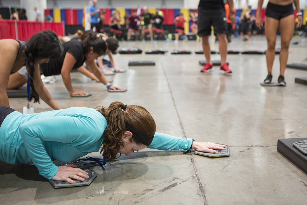 Attendee Tania Weissman participates in a workout during the IDEA World Fitness & Nutrition Expo at the Las Vegas Convention Center in Las Vegas on Thursday, July 20, 2017.  Bridget Bennett La ...