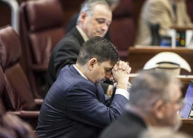 Sen. Mark Manendo, D-Las Vegas, bows his head during a moment of silence during the third day of the Nevada Legislative session on Wednesday, Feb. 8, 2017, at the Legislative Building, in Carson C ...
