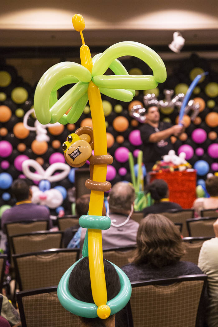 Convention attendees wear colorful attire while listening to Fabrizio Bolzoni lead a balloon art class during the Bling Bling Jam Balloon Convention on Tuesday, July 25, 2017, at the Golden Nugget ...