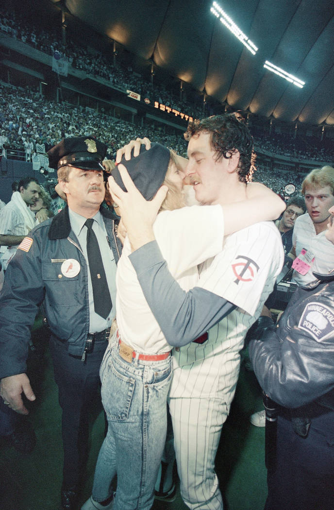 Minnesota Twins pitcher Frank Viola and his wife Kathy share an embrace in the Metrodome, Sunday, Oct. 26, 1987 in Minneapolis after the Twins won the World Series four games to three. (AP Photo)