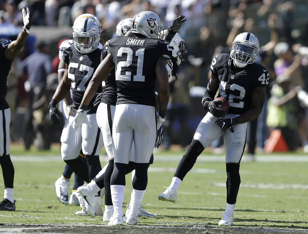 Oakland Raiders safety Karl Joseph (42) celebrates after intercepting a pass against the San Diego Chargers during the second half of an NFL football game in Oakland, Calif., Sunday, Oct. 9, 2016. ...