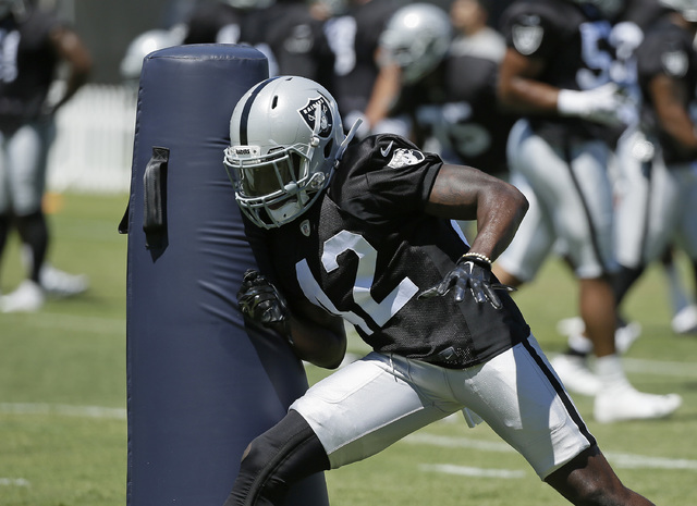 Oakland Raiders safety Karl Joseph hits a dummy during practice at the NFL football team's training camp Friday, July 29, 2016, in Napa, Calif. (AP Photo/Eric Risberg)