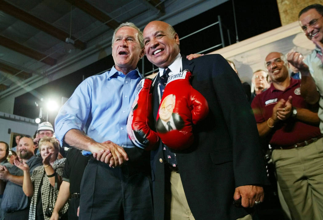 President Bush, left, greets Joe Cortez, right, a boxing referee, after autographing boxing gloves with the images of Bush and Vice President Cheney on them, during a campaign rally at the United  ...