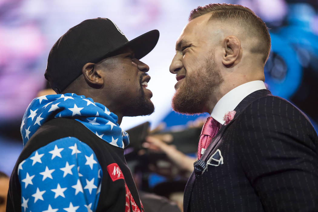 Boxer Floyd Mayweather Jr., left, and UFC fighter Conor McGregor during a press conference in their world boxing tour to promote their upcoming fight, at Staples Center in Los Angeles on Tuesday,  ...