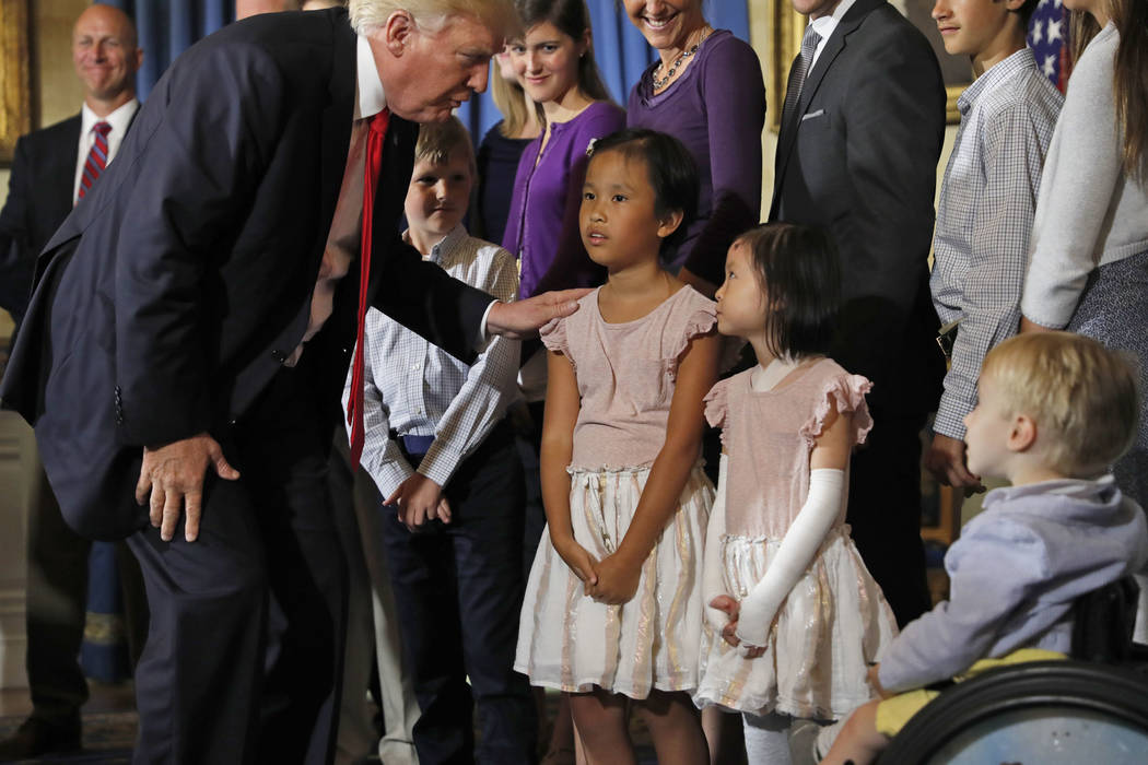 President Donald Trump greets families that oppose Obamacare during an event about healthcare, Monday, July 24, 2017, in the Blue Room of the White House in Washington. (AP Photo/Alex Brandon)