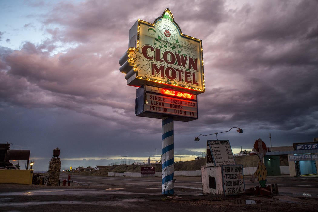 The Clown Motel sign glows as the sun sets along Main Street in Tonopah on Tuesday, July 25, 2017. The Clown is currently for sale with the condition that the new owner must keep the clown theme.  ...