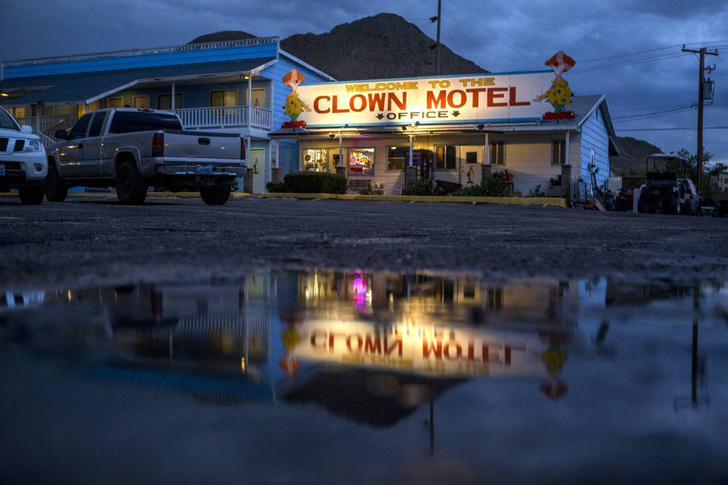 The office of the Clown Motel is reflected in a puddle at dusk in Tonopah on Tuesday, July 25, 2017. The Clown is currently for sale with the condition that the new owner must keep the clown theme ...
