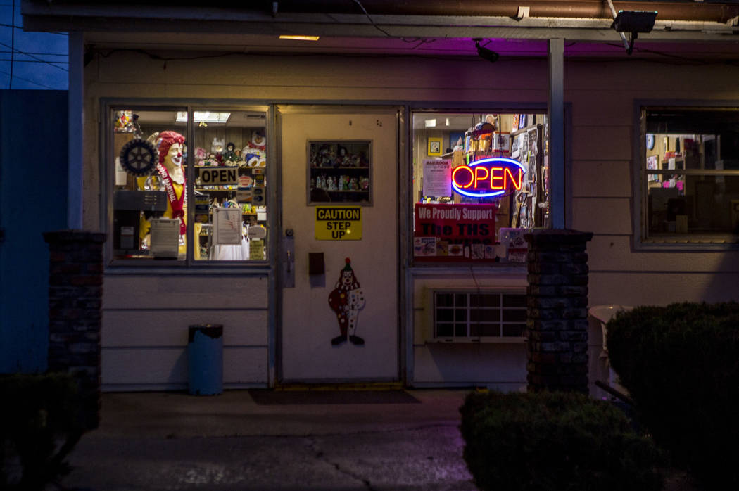 Warm lights glow at dusk outside of the Clown Motel office in Tonopah on Tuesday, July 25, 2017. The Clown is currently for sale with the condition that the new owner must keep the clown theme.  P ...
