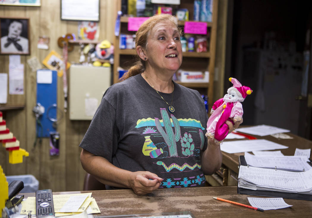 Marlena Dufour accepts a new clown donation at the Clown Motel in Tonopah on Tuesday, July 25, 2017. Visitors have traveled from around the world to stay at the motel, and many have brought clown  ...