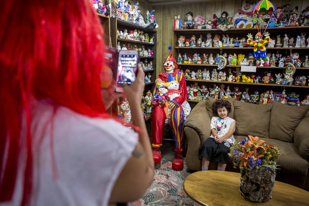 Penny James takes a photo of her son Kai, 9, in the lobby of the Clown Motel in Tonopah on Tuesday, July 25, 2017. The Las Vegas residents came to stay for a night and dressed up in clown attire.  ...