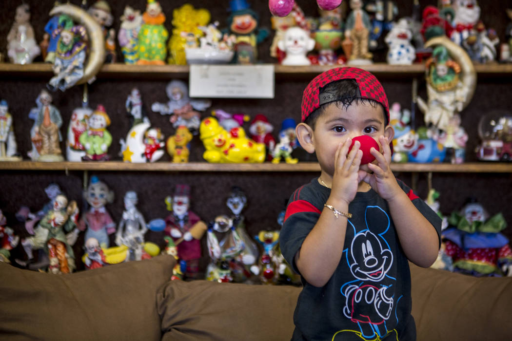 Sky Duran, 2, the son of a motel guest, tries on a clown nose in the lobby of the Clown Motel in Tonopah on Wednesday, July 26, 2017. The Clown is currently for sale with the condition that the ne ...