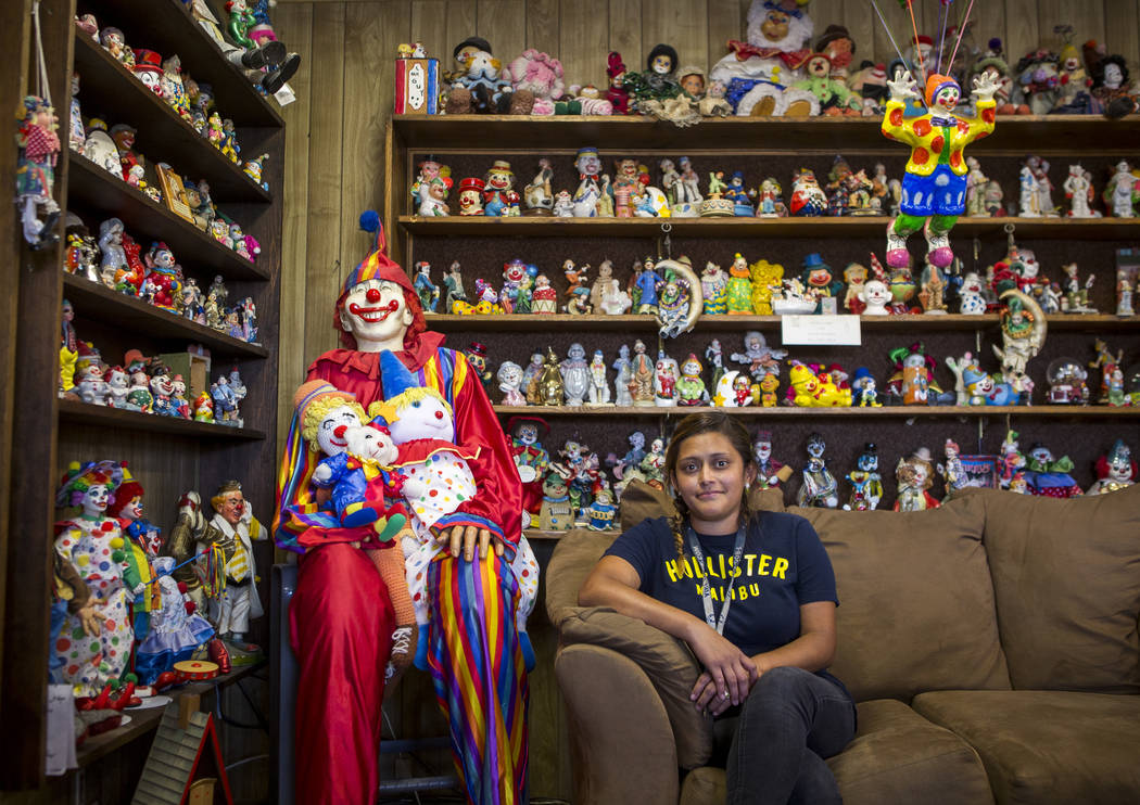 Lisbi Bravo, a housekeeper, sits among about 600 clowns in the lobby of the Clown Motel in Tonopah on Wednesday, July 26, 2017. Bravo has worked at the Clown Motel for four months and began experi ...