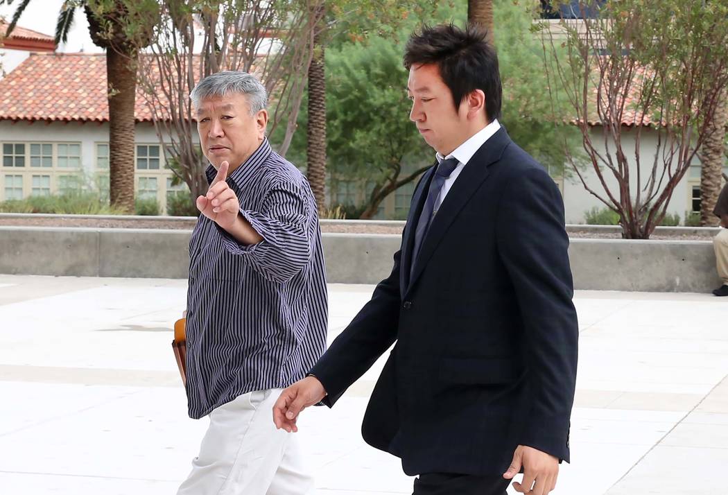 Jianguo Han, left, and his son Bing, accused of growing hundreds of marijuana plants, arrive at the Lloyd George U.S. Courthouse on Tuesday, July 25, 2017, in Las Vegas. Bizuayehu Tesfaye Las Vega ...