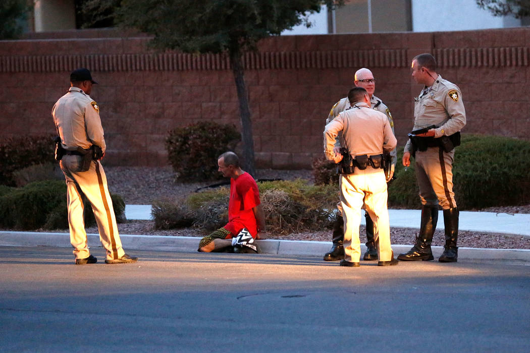 Police officers investigate an officer-involved shooting on North Goldfield Street in North Las Vegas, Monday, July 24, 2017. According to police, two people have been shot and taken to local hosp ...