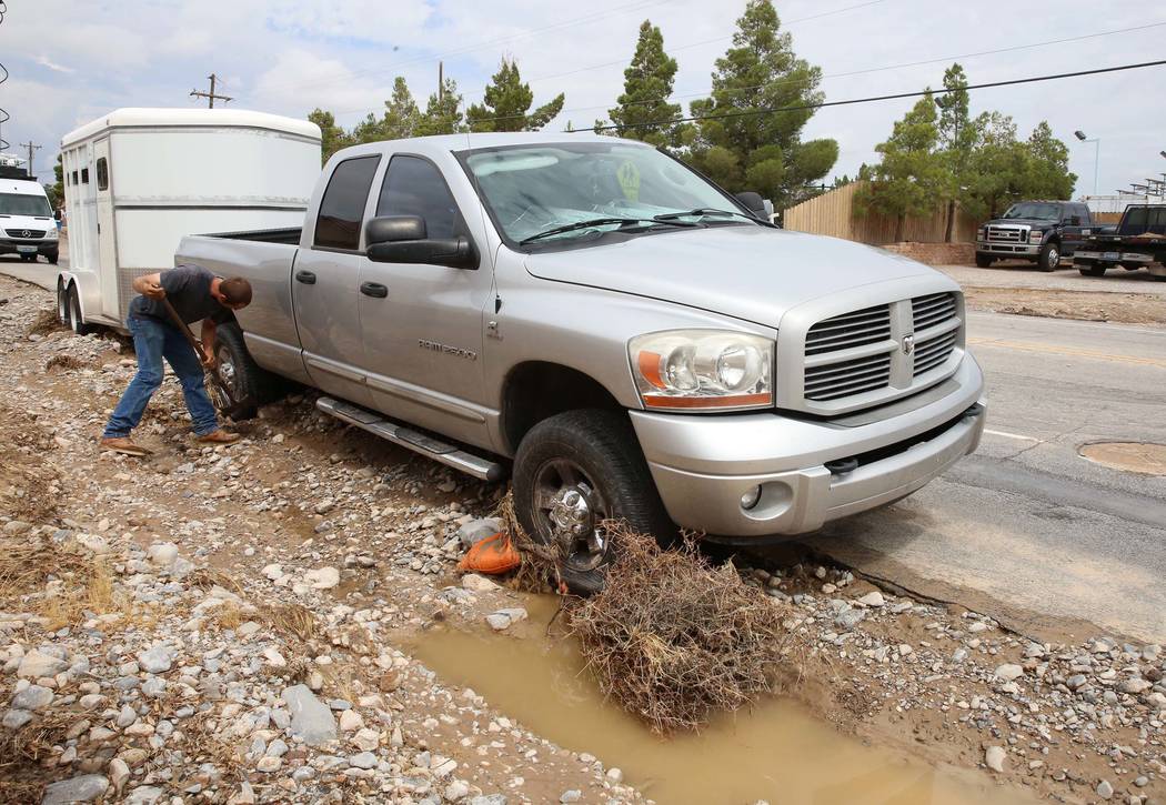 Clinton Jacob tries to free his truck and horse trailer from flood debris outside his home on Brent Lane on Tuesday, July 25, 2017, in Las Vegas. (Bizuayehu Tesfaye/Las Vegas Review-Journal) @bizu ...