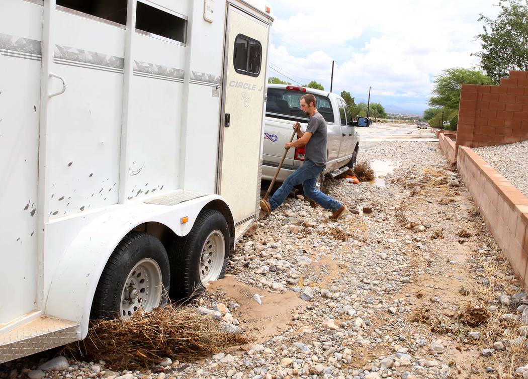 Clinton Jacob tries to free his truck and horse trailer from flood debris outside his home on Brent Lane on Tuesday, July 25, 2017, in Las Vegas. Bizuayehu Tesfaye Las Vegas Review-Journal @bizute ...