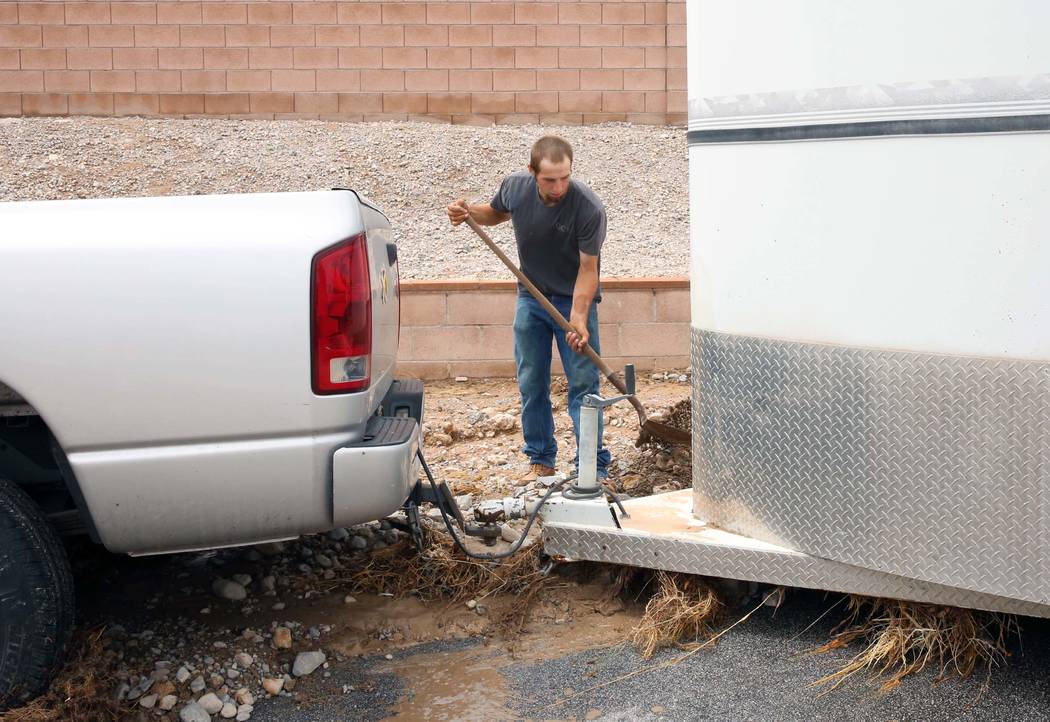 Clinton Jacob tries to free his truck and horse trailer from flood debris outside his home on Brent Lane on Tuesday, July 25, 2017, in Las Vegas. (Bizuayehu Tesfaye/Las Vegas Review-Journal) @bizu ...