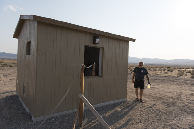 Larry Levy, fire chief for the Southern Inyo Fire Protection District, walks around the shed for a potable water vending machine in Tecopa, Calif. on June 21, 2016. The vending machine went into o ...