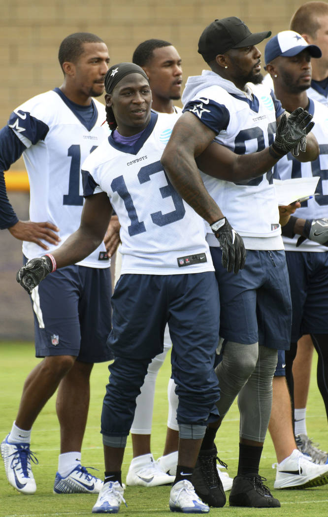 Dallas Cowboys wide receiver Lucky Whitehead (13) jokes with Dez Bryant, front-right, during practice at the NFL football team's training camp in Oxnard, Calif., Monday, July 24, 2017. (AP Photo/M ...